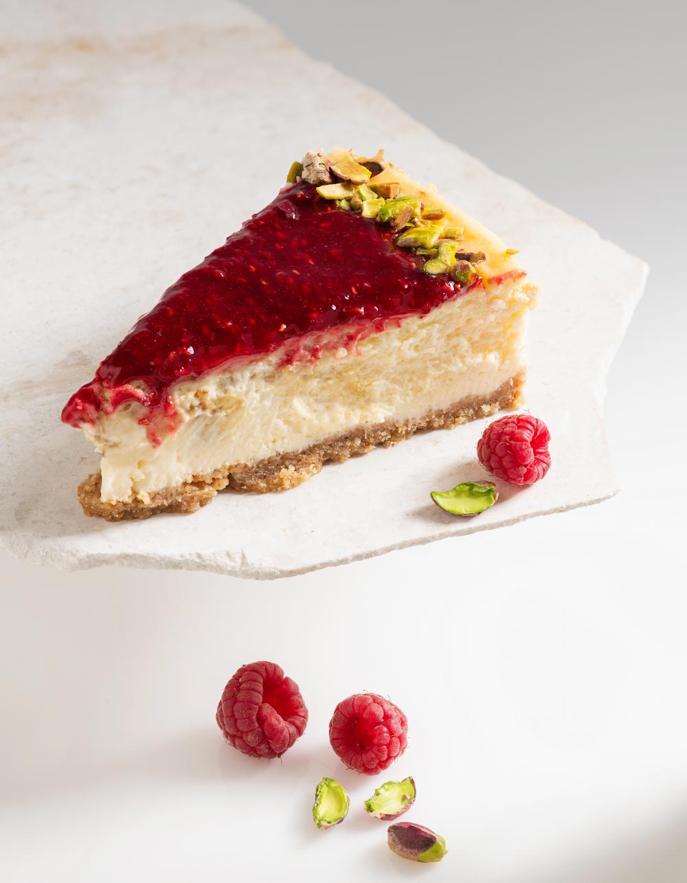 Slice of Pistachio & Raspberry Cheesecake. Cheesecake Club by Rubi. 2023